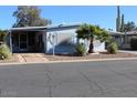 Front view of manufactured home with covered patio and landscaping at 303 S Recker Rd # 9, Mesa, AZ 85206