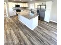 Spacious kitchen with granite countertops and stainless steel appliances at 34902 W Caldwell St, Tonopah, AZ 85354