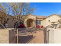 Front entry of the house with a paved walkway and wrought iron gate at 3630 W Bohl St, Laveen, AZ 85339