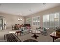 Spacious living room with hardwood floors, formal furniture, and large windows at 3817 E Cielo Grande Ave, Phoenix, AZ 85050