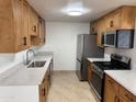 Modern kitchen featuring stainless steel appliances and light wood cabinets at 3941 E Emile Zola Ave, Phoenix, AZ 85032