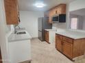 Kitchen with wood cabinets and quartz countertops at 3941 E Emile Zola Ave, Phoenix, AZ 85032