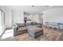 Spacious living room featuring a sectional sofa and a dining area at 40465 W Chambers Dr, Maricopa, AZ 85138