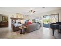 Spacious living room with fireplace and large windows at 42028 N Crooked Stick Rd, Anthem, AZ 85086