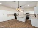 Modern kitchen with white cabinets, stainless steel appliances, and an island at 4249 S Pony Rider Trl, Gold Canyon, AZ 85118