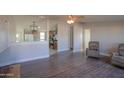 Living room with hardwood floors and a view of the kitchen at 49651 W Dune Shadow Rd, Maricopa, AZ 85139