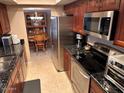 Modern kitchen with stainless steel appliances and granite countertops at 5215 W Acapulco W Ln, Glendale, AZ 85306