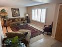 Spacious living room featuring a comfortable seating area and large windows at 5215 W Acapulco W Ln, Glendale, AZ 85306