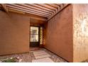 Inviting entryway with a pergola and stained glass at 5640 E Bell Rd # 1101, Scottsdale, AZ 85254