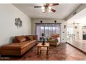 Spacious living room with leather furniture and tiled floors at 5640 E Bell Rd # 1101, Scottsdale, AZ 85254