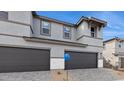 Contemporary two-story home featuring a gray exterior, two-car garage, and desert landscaping at 5819 E Rose Garden Ln, Phoenix, AZ 85054