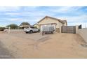 Home's front view showcasing a paved driveway and a gated entrance at 5830 E Fox Hollow Ln, San Tan Valley, AZ 85140