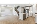 Modern kitchen with island, stainless steel appliances, and white cabinets at 5846 E Ringtail Way, Phoenix, AZ 85054