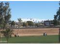 Stunning aerial view of property showcasing snow-capped mountains in the background at 7800 E Lincoln Dr # 1029, Scottsdale, AZ 85250