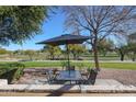 Relaxing patio with seating area and umbrella, overlooking a golf course at 7800 E Lincoln Dr # 1029, Scottsdale, AZ 85250