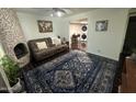 Living area with fireplace, couch and patterned rug at 8014 E Oak St, Scottsdale, AZ 85257