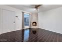 Bright living room featuring a fireplace and dark hardwood floors at 8014 E Oak St, Scottsdale, AZ 85257