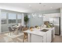 Modern kitchen with island, white cabinets, and stainless steel appliances at 8235 E Petunia Ave, Mesa, AZ 85212