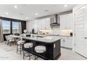 Modern kitchen with white cabinets, a large island, and stainless steel appliances at 9831 S 11Th St, Phoenix, AZ 85042