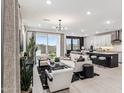 Open concept living room features modern furniture and a view of the backyard at 9831 S 11Th St, Phoenix, AZ 85042