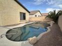 Inviting kidney-shaped pool with surrounding landscaping at 10241 W Florence Ave, Tolleson, AZ 85353