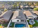 Aerial view of house, pool and backyard, in a residential neighborhood at 10808 W Cottontail Ln, Peoria, AZ 85383