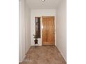 Bright entryway with tile flooring and wood door at 1201 W Ducasse Dr, Phoenix, AZ 85013