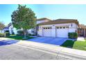 Tan house with two-car garage and well-maintained lawn at 1201 W Ducasse Dr, Phoenix, AZ 85013