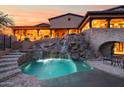 Private pool and waterfall feature in a luxurious backyard oasis at 16117 E Shooting Star Trl, Fountain Hills, AZ 85268