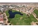 Breathtaking aerial view of the golf course community with a picturesque pond and well-maintained greens at 319 S 227Th Ct, Buckeye, AZ 85326