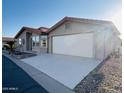 Single-story home with a red tile roof, two-car garage, and a well-maintained driveway at 3301 S Goldfield Rd # 3038, Apache Junction, AZ 85119