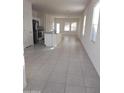 Open concept kitchen with an island, stainless steel appliances, and tile flooring at 36061 W Santa Clara Ave, Maricopa, AZ 85138