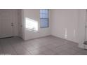 Bright and airy living room with tile flooring and neutral wall colors at 36061 W Santa Clara Ave, Maricopa, AZ 85138