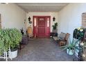 Inviting entryway with red door and seating area at 5301 W Cambridge Ave, Phoenix, AZ 85035