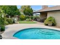 Inviting kidney-shaped pool with a spacious patio area at 5345 E Evans Dr, Scottsdale, AZ 85254