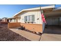 Side view of a ranch-style home with brick accents at 10620 W Clair Dr, Sun City, AZ 85351