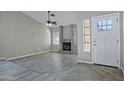 Living room with fireplace, wood-look floors, and high ceilings at 10934 E Becker Ln, Scottsdale, AZ 85259