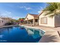 Spacious backyard with a refreshing pool and ample patio space at 11122 N 165Th Ave, Surprise, AZ 85388