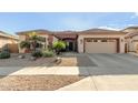 Single-story home with two-car garage and desert landscaping at 11122 N 165Th Ave, Surprise, AZ 85388