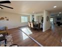 Open dining area with hardwood floors and a table for six at 11808 S Half Moon Dr, Phoenix, AZ 85044