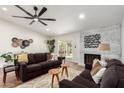 Spacious living room with hardwood floors, ceiling fan, and a fireplace at 11808 S Half Moon Dr, Phoenix, AZ 85044