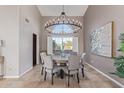 Formal dining room featuring a decorative chandelier, large window, and seating for six at 15237 S 19Th Way, Phoenix, AZ 85048