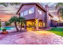 Two-story home with a large stone patio and pool at 15237 S 19Th Way, Phoenix, AZ 85048