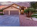 Beautiful home exterior showcasing a two-car garage, front door, and desert landscaping at 15237 S 19Th Way, Phoenix, AZ 85048
