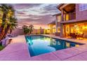 Inviting swimming pool with patio and seating area at sunset at 15237 S 19Th Way, Phoenix, AZ 85048