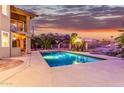 Relaxing rectangular pool with surrounding patio at sunset at 15237 S 19Th Way, Phoenix, AZ 85048