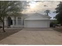 White stucco house with a two-car garage and desert landscaping at 15869 E Ponderosa Dr, Fountain Hills, AZ 85268