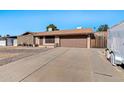 Single story home with a two car garage and large driveway at 1604 W Kerry Ln, Phoenix, AZ 85027