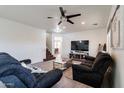 Living room with two comfy sofas, a coffee table, and a large TV at 1647 W Gold Mine Way, San Tan Valley, AZ 85144