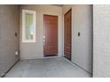 Modern entryway with a brown door and neutral-colored walls at 16747 W Cielo Grande Ave, Surprise, AZ 85387